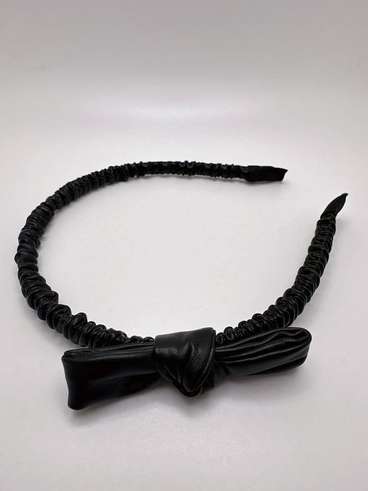 
                  
                    Faux leather bow headband
                  
                